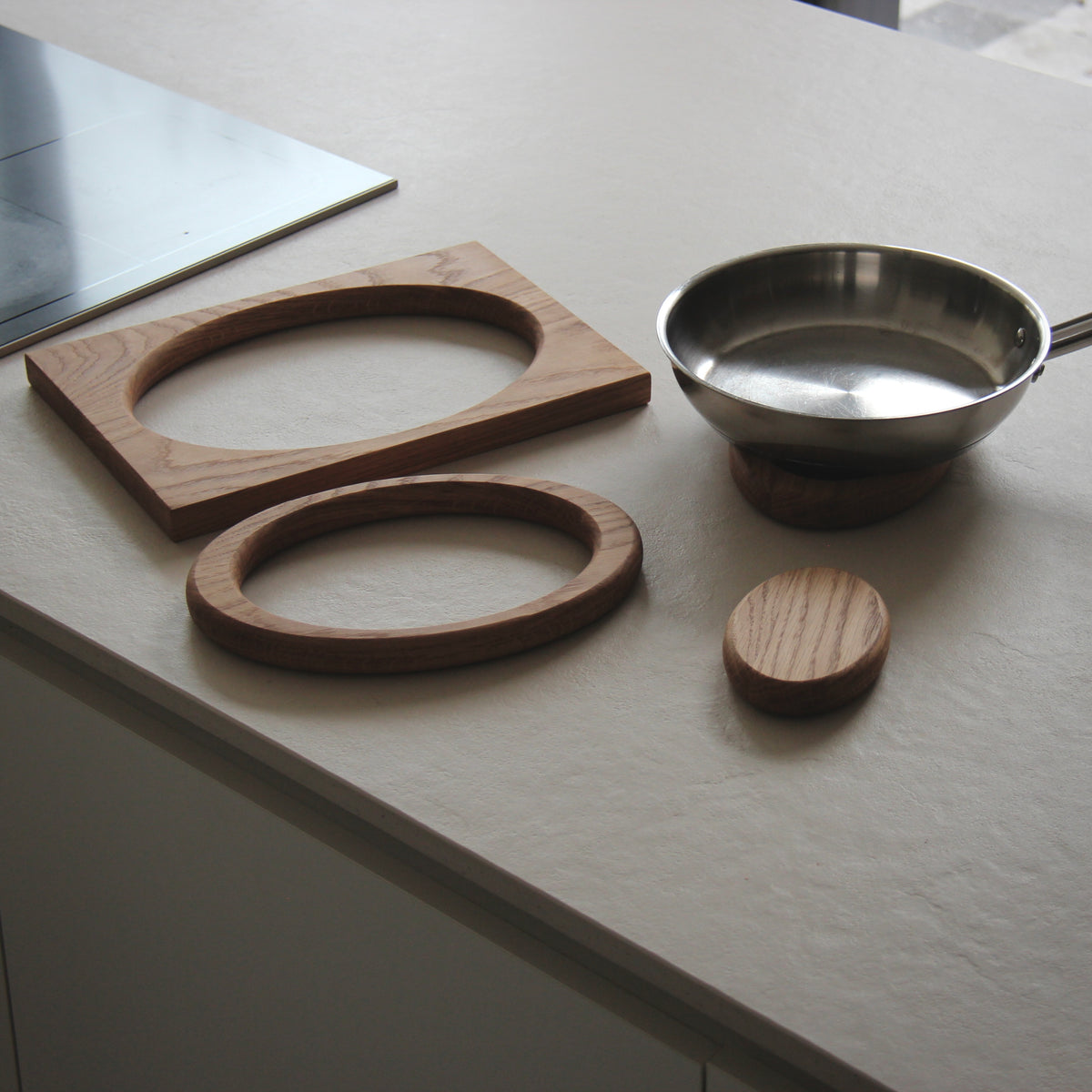 Oval Trivet in oak with individual pieces arranged on a table